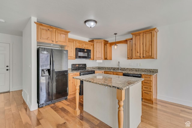 2074 S Orchard Dr, Bountiful, UT 84010 - kitchen featuring light stone counters, a sink, light wood-type flooring, baseboards, and black appliances