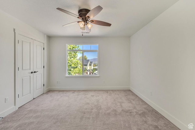 2074 S Orchard Dr, Bountiful, UT 84010 - unfurnished bedroom with light carpet, visible vents, baseboards, a closet, and ceiling fan