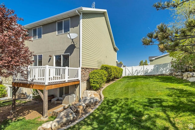 2074 S Orchard Dr, Bountiful, UT 84010 - back of house with stone siding, fence, a yard, cooling unit, and a wooden deck