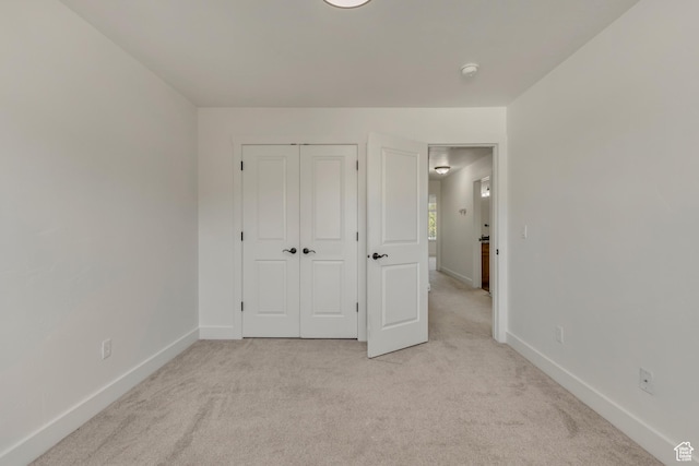 2074 S Orchard Dr, Bountiful, UT 84010 - unfurnished bedroom featuring baseboards, a closet, and light colored carpet