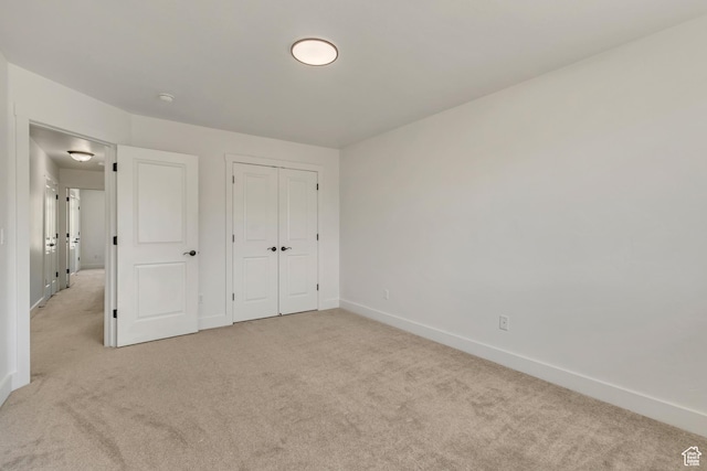 2074 S Orchard Dr, Bountiful, UT 84010 - unfurnished bedroom featuring light carpet, a closet, and baseboards