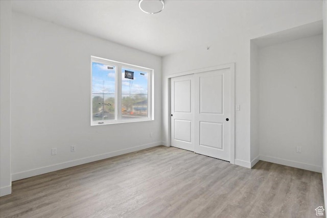 805 S 800 W Unit D, Salt Lake City, UT 84104 - unfurnished bedroom featuring light wood-style flooring, a closet, and baseboards