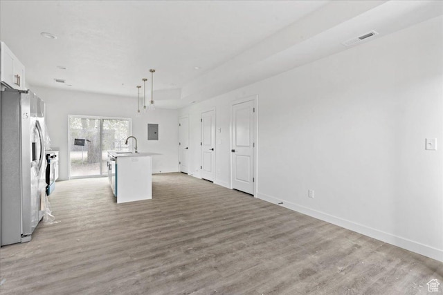805 S 800 W Unit D, Salt Lake City, UT 84104 - unfurnished living room with baseboards, visible vents, a sink, and light wood finished floors