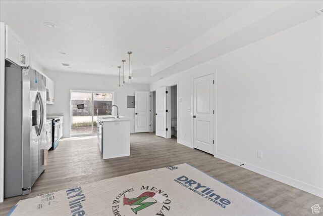 805 S 800 W Unit D, Salt Lake City, UT 84104 - kitchen featuring a sink, wood finished floors, stainless steel fridge, light countertops, and white cabinetry