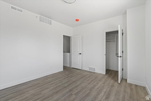805 S 800 W Unit D, Salt Lake City, UT 84104 - unfurnished bedroom with wood finished floors, visible vents, and baseboards