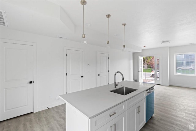 805 S 800 W Unit D, Salt Lake City, UT 84104 - kitchen with white cabinets, stainless steel dishwasher, light wood-style flooring, a sink, and baseboards