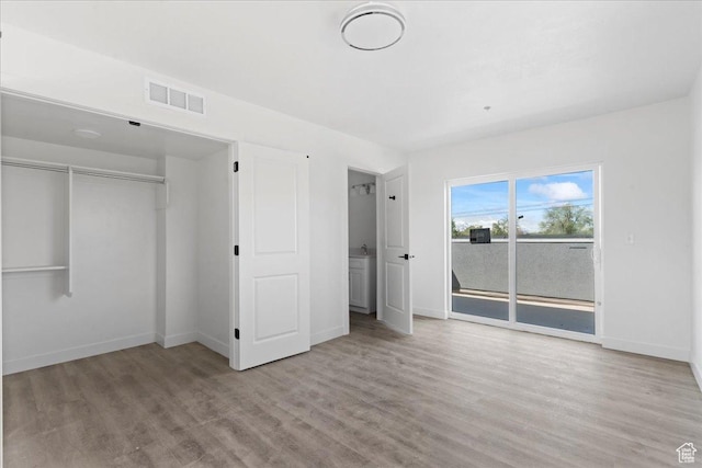 805 S 800 W Unit D, Salt Lake City, UT 84104 - unfurnished bedroom with wood finished floors, visible vents, and baseboards