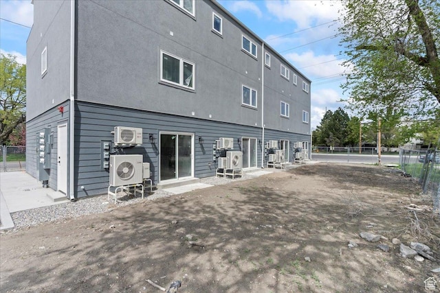 805 S 800 W Unit D, Salt Lake City, UT 84104 - back of house featuring stucco siding, fence, and ac unit