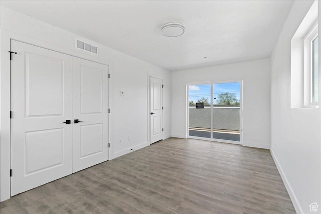 805 S 800 W Unit D, Salt Lake City, UT 84104 - unfurnished bedroom with wood finished floors, visible vents, baseboards, and access to exterior