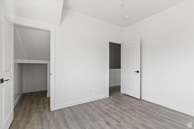 805 S 800 W Unit D, Salt Lake City, UT 84104 - unfurnished bedroom with visible vents, baseboards, and wood finished floors