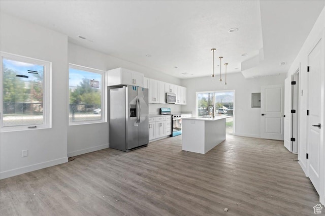 805 S 800 W Unit D, Salt Lake City, UT 84104 - kitchen with light wood finished floors, a kitchen island with sink, appliances with stainless steel finishes, and a sink