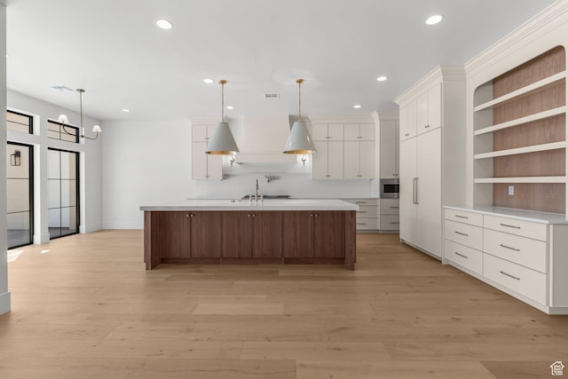 3382 E Ezra Ln, St George, UT 84790 - kitchen with recessed lighting, light wood-style flooring, a large island with sink, and white cabinetry