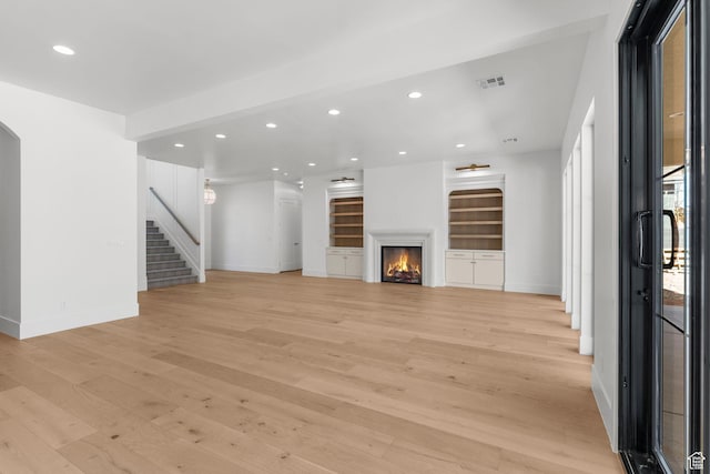 3382 E Ezra Ln, St George, UT 84790 - unfurnished living room with stairway, light wood-style flooring, baseboards, visible vents, and recessed lighting