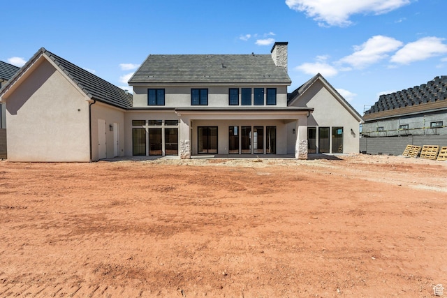 3382 E Ezra Ln, St George, UT 84790 - rear view of property featuring stucco siding and a chimney