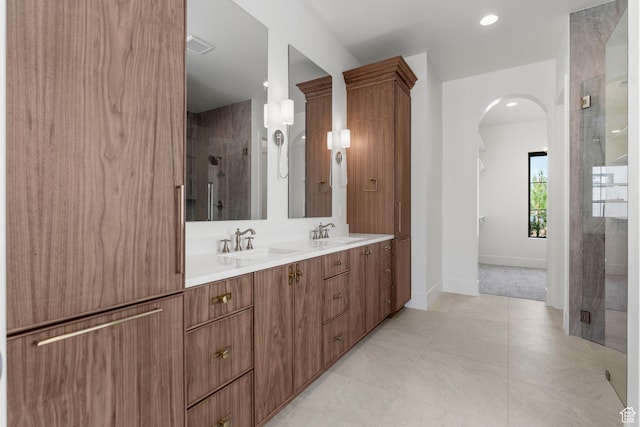 3382 E Ezra Ln, St George, UT 84790 - bathroom featuring double vanity, a shower stall, baseboards, and a sink