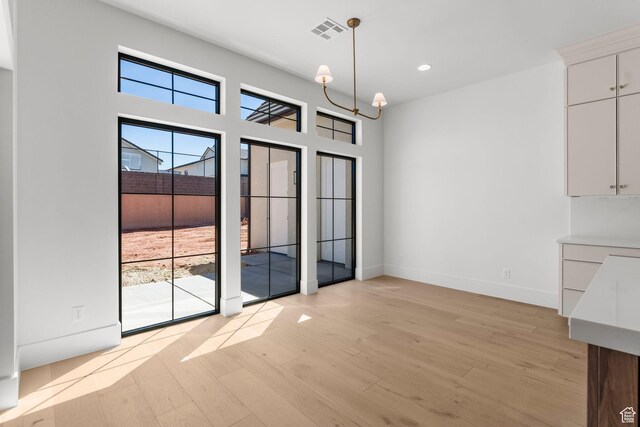 3382 E Ezra Ln, St George, UT 84790 - unfurnished dining area featuring recessed lighting, an inviting chandelier, visible vents, baseboards, and light wood-style flooring