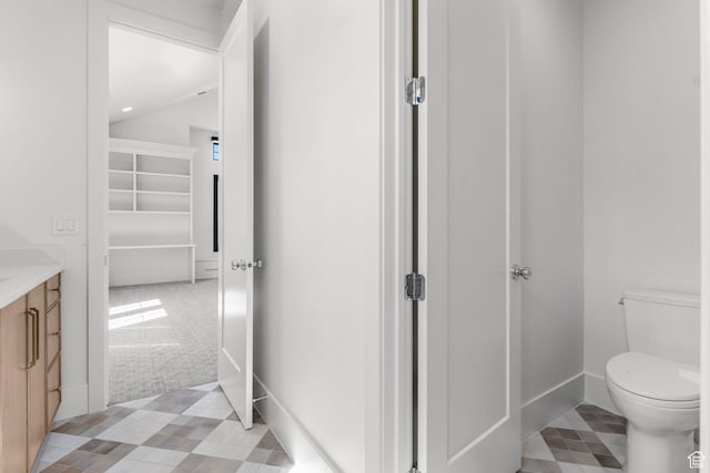 3382 E Ezra Ln, St George, UT 84790 - bathroom featuring toilet, vanity, vaulted ceiling, and baseboards