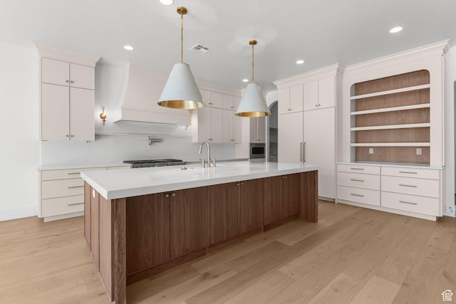 3382 E Ezra Ln, St George, UT 84790 - kitchen featuring white cabinets, recessed lighting, a large island, light countertops, and light wood-style flooring