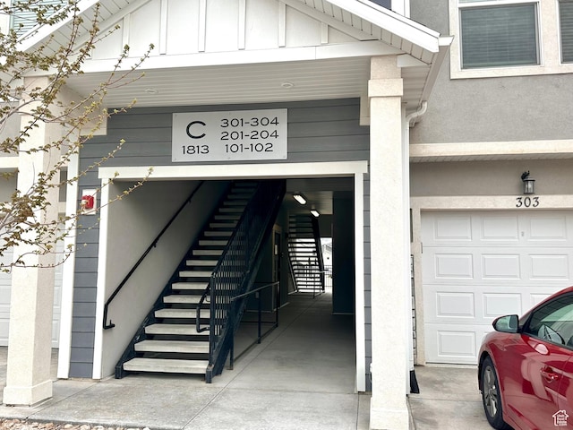 property entrance with stucco siding and board and batten siding
