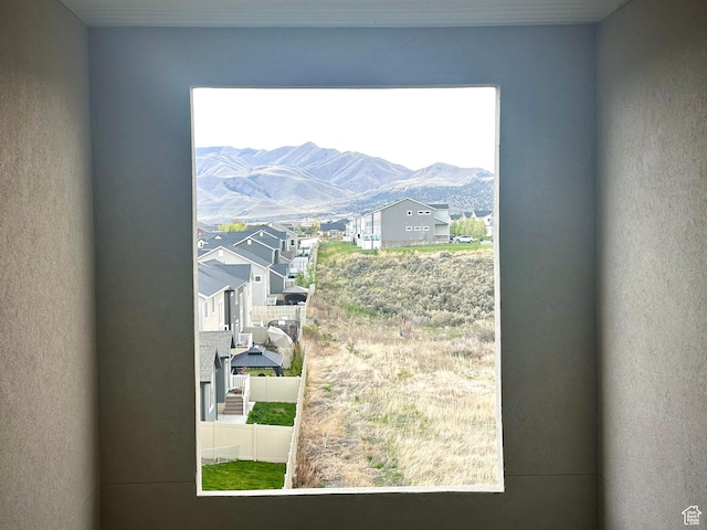 doorway with a residential view, a mountain view, and a wealth of natural light