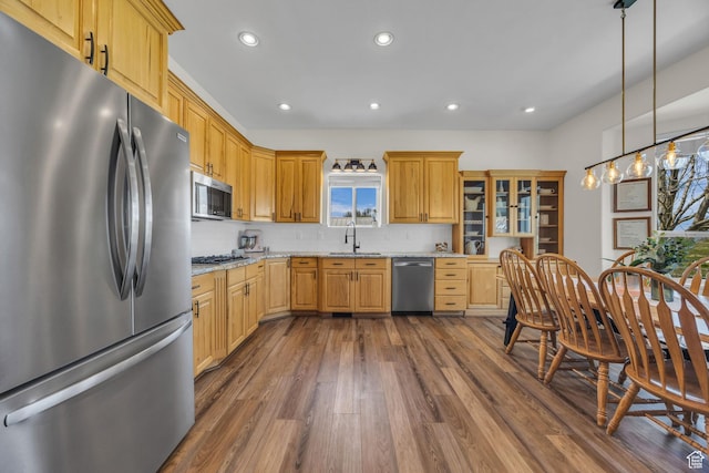 1563 Bryan Rd, Erda, UT 84074 - kitchen with a sink, dark wood finished floors, recessed lighting, light stone counters, and appliances with stainless steel finishes