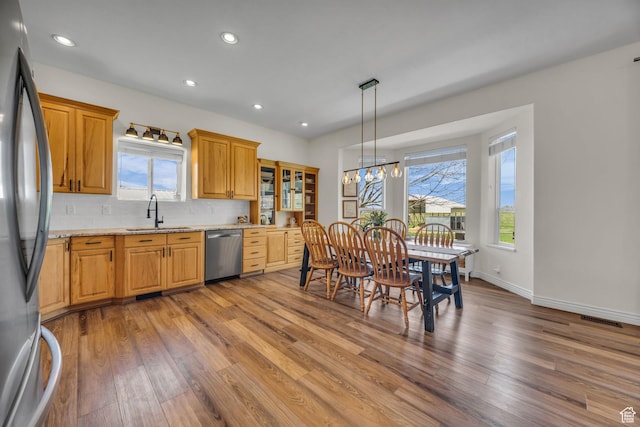 1563 Bryan Rd, Erda, UT 84074 - kitchen with wood finished floors, stainless steel appliances, visible vents, and a sink