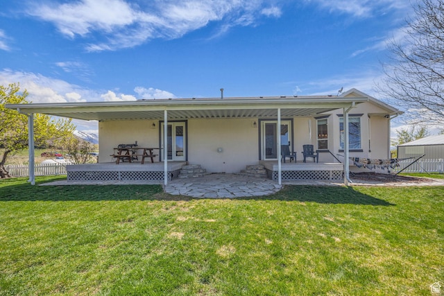 1563 Bryan Rd, Erda, UT 84074 - rear view of property with stucco siding, fence, a patio area, and a yard