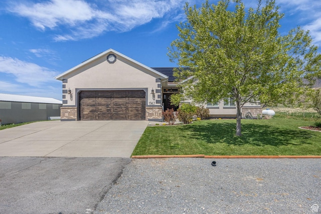 ranch-style house with a garage, brick siding, a front lawn, and concrete driveway