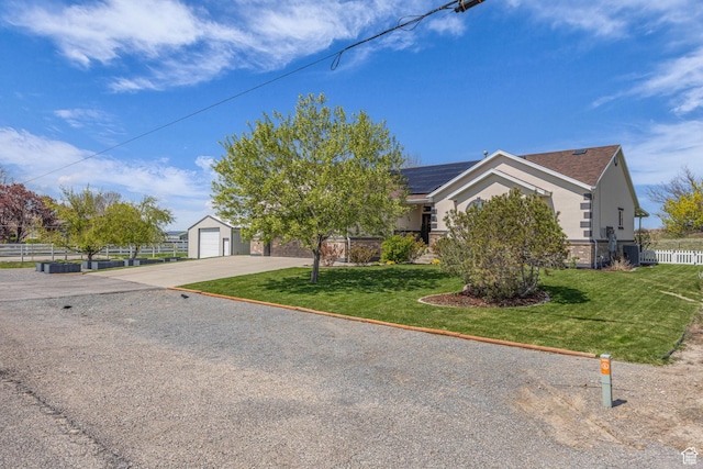 1563 Bryan Rd, Erda, UT 84074 - obstructed view of property with a shingled roof, roof mounted solar panels, fence, a front yard, and stucco siding