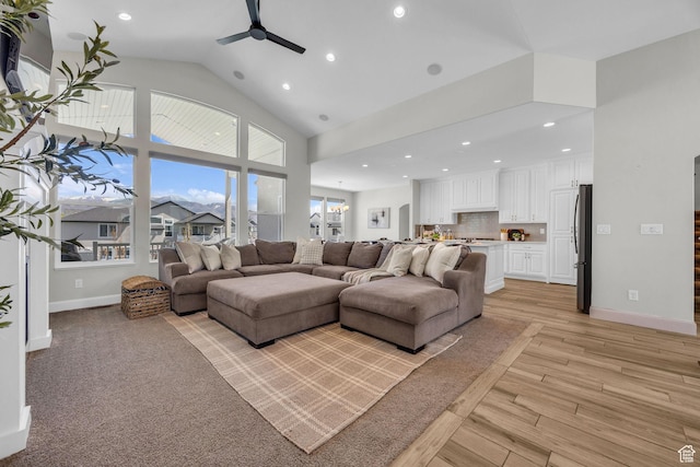2364 N 2400 W, Farr West, UT 84404 - living area featuring high vaulted ceiling, light wood-style floors, ceiling fan, baseboards, and recessed lighting