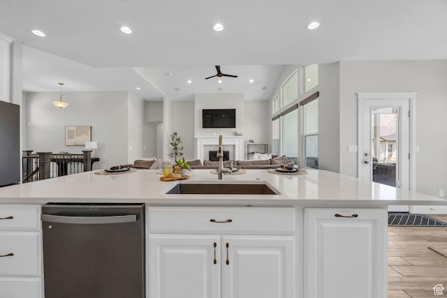 2364 N 2400 W, Farr West, UT 84404 - kitchen featuring stainless steel dishwasher, a sink, light wood-style floors, ceiling fan, and light countertops