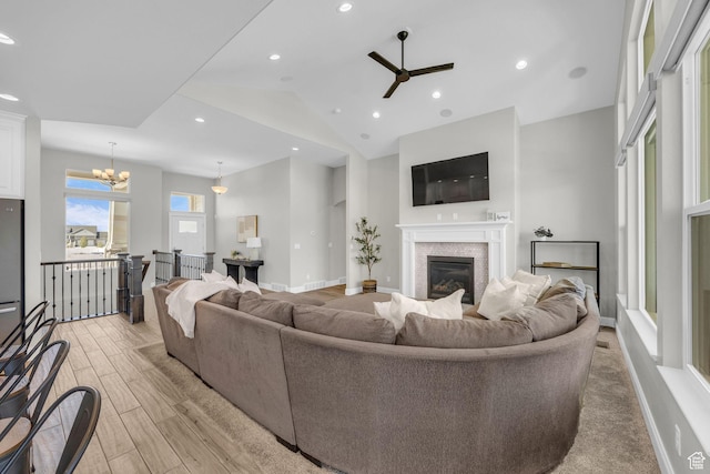 2364 N 2400 W, Farr West, UT 84404 - living room featuring ceiling fan with notable chandelier, a glass covered fireplace, light wood-type flooring, baseboards, and recessed lighting