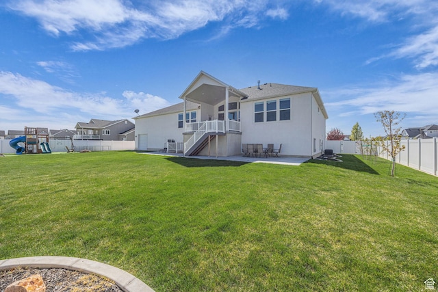 2364 N 2400 W, Farr West, UT 84404 - back of property featuring a fenced backyard, a playground, stairway, a yard, and a patio