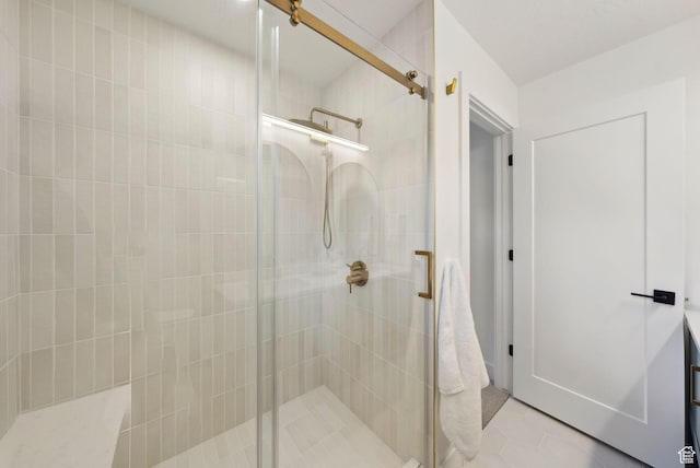 full bath with a shower stall and tile patterned floors