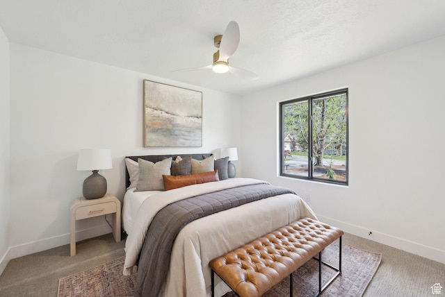 bedroom featuring a ceiling fan, baseboards, and carpet