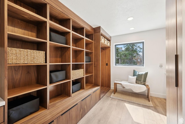 mudroom with baseboards, recessed lighting, and light wood-style floors