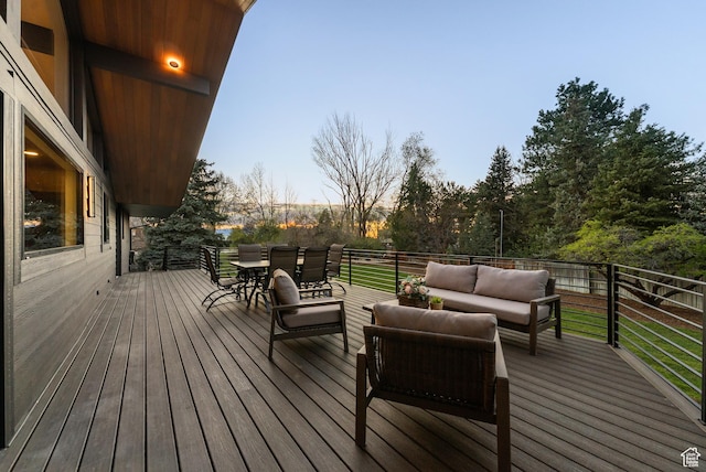 deck with outdoor lounge area and outdoor dining space