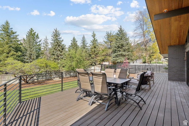 deck featuring outdoor dining area and fence