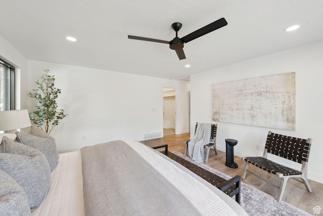 bedroom featuring wood finished floors, ceiling fan, baseboards, visible vents, and recessed lighting