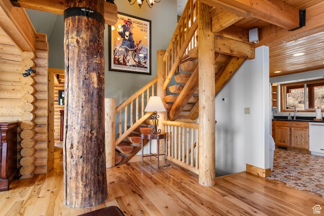 2292 S Aspen Loop, Garden City, UT 84028 - stairway with hardwood / wood-style floors, log walls, beam ceiling, and recessed lighting