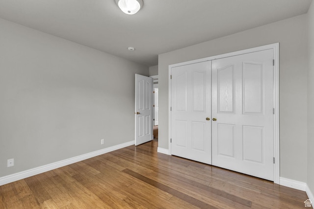 305 E 3700 N, North Ogden, UT 84414 - unfurnished bedroom featuring baseboards, wood finished floors, and a closet