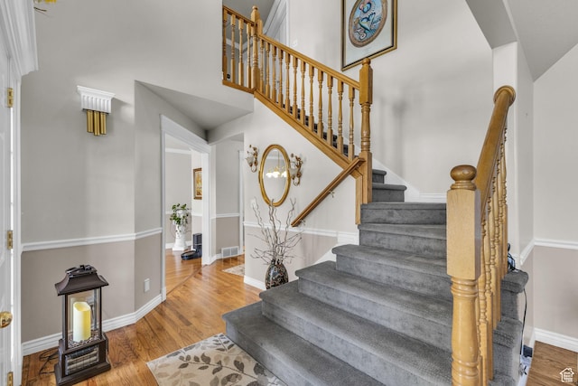 305 E 3700 N, North Ogden, UT 84414 - stairway featuring a high ceiling, baseboards, wood finished floors, and visible vents