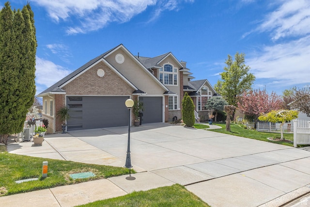 305 E 3700 N, North Ogden, UT 84414 - traditional home featuring a front lawn, driveway, an attached garage, fence, and brick siding