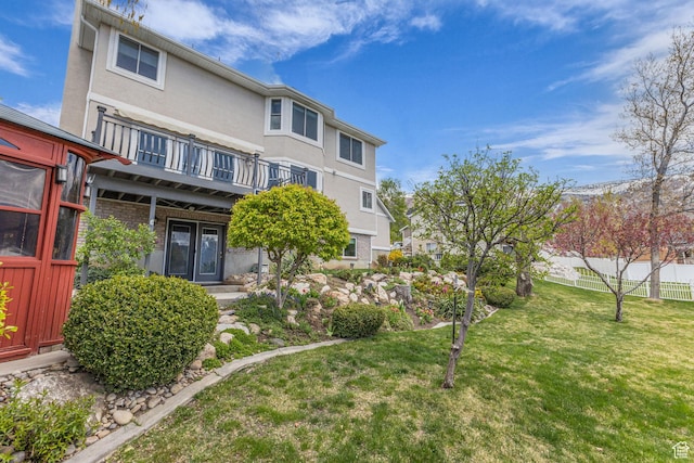 305 E 3700 N, North Ogden, UT 84414 - rear view of house featuring a yard, a balcony, stucco siding, and fence