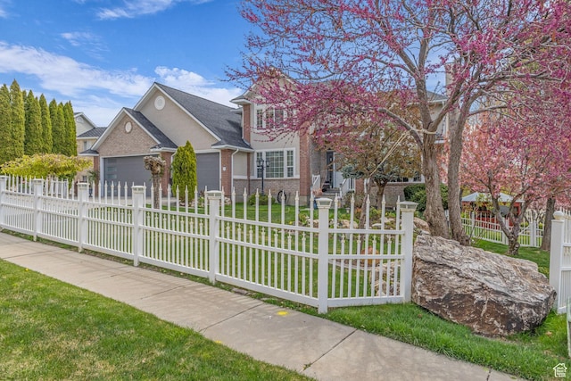 305 E 3700 N, North Ogden, UT 84414 - view of front facade with a fenced front yard, driveway, an attached garage, a front yard, and brick siding