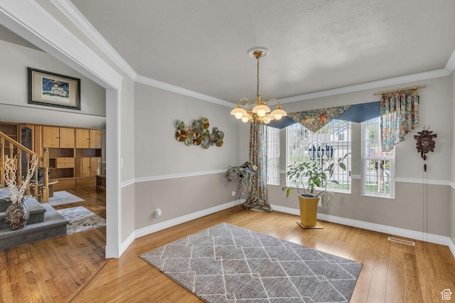 305 E 3700 N, North Ogden, UT 84414 - dining area featuring visible vents, a notable chandelier, wood finished floors, stairway, and crown molding