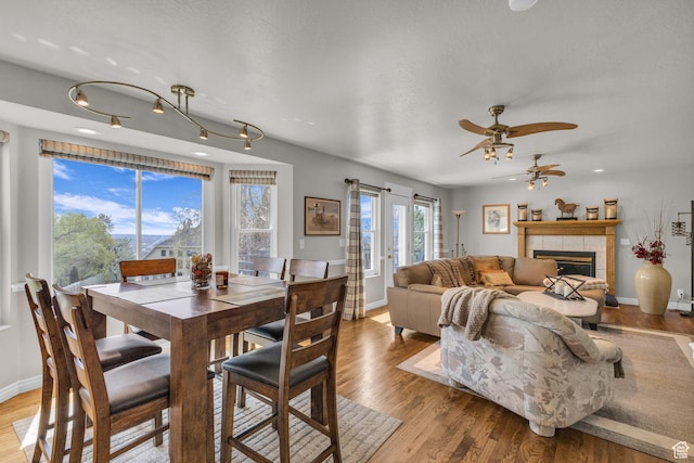 305 E 3700 N, North Ogden, UT 84414 - dining room with a fireplace, light wood-style flooring, baseboards, and ceiling fan