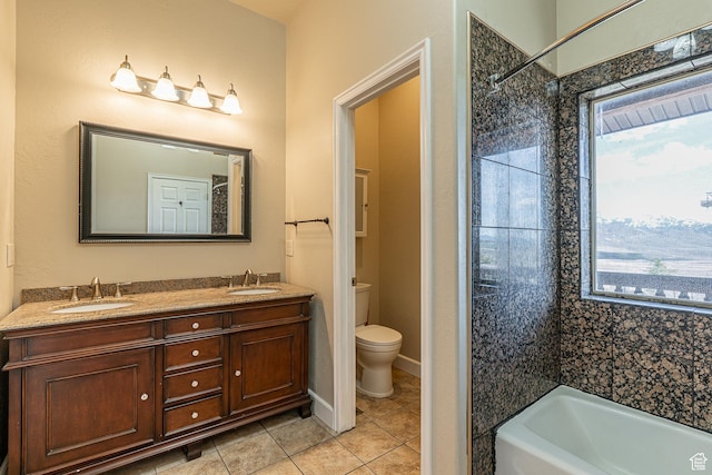 full bath with a tub to relax in, tile patterned floors, toilet, and a sink