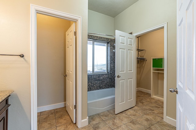 bathroom with baseboards, tile patterned flooring, a shower, vanity, and a tub