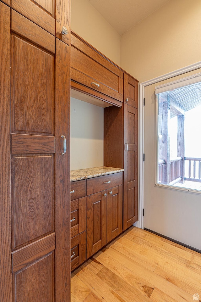 kitchen featuring brown cabinetry and light wood-style flooring